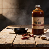 THE FEEDLOT Trailblazer Texas Style BBQ Sauce - beauty shot on barn wood with cast iron