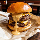 Loaded beef burger on a brioche bun with a creamy sauce and melted cheese
