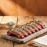 Outlaw Barbecue Bushranger A.P.R. 300g all purpose BBQ rub — raw beef ribs coated in seasoning, ready to cook