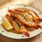 Outlaw Barbecue Gold Rush 280g garlic butter BBQ rub — split king prawns glistening with garlic butter and thyme