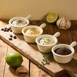 Outlaw Barbecue four pack BBQ rub bundle — four seasoning blends in enamel bowls on a timber board
