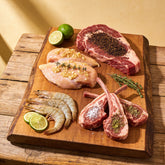 Outlaw Barbecue four pack BBQ rub bundle — raw steak, chicken, prawns and lamb chops each seasoned with a different blend