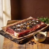 Outlaw Barbecue Stockman CRUST 250g espresso beef rub — raw brisket heavily rubbed with coffee-pepper seasoning, ready to cook