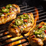 El Chori Hot Jalapeño Chimichurri — chicken thighs basted with jalapeño chimichurri on a flaming grill