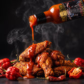 Reapers Roulette hot sauce drizzled over a pile of hot chicken wings