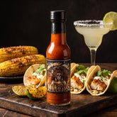 Dia De Los Muertos habanero margarita hot sauce styled with fish tacos and corn