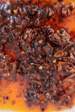 Close-up of Ma Foo Chilli Oil showing crispy shallot, chilli flake and seeds in amber-red oil