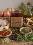 Nonna Piccante Chilli Oil jar styled with its ingredients including porcini, capers, fennel seeds and oregano