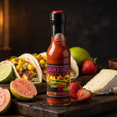 Punk Rock Peppers Pink Flameingo hot sauce styled with tacos, guava and strawberry