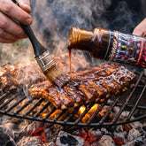 Championship Candy glaze brushed onto ribs on the grill