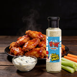 Atomic Chicken Blue Cheese Sauce 250ml — bowl of buffalo wings with the bottle and creamy blue cheese dip