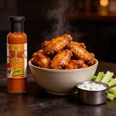 Atomic Chicken Buffalo Hot Sauce 250ml — bowl of glossy buffalo wings with blue cheese dip and celery