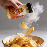 Atomic Chicken Chicken Salt Seasoning 330g — chicken salt shaken over a bowl of chips, seasoning frozen mid-air