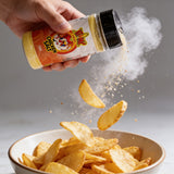 Atomic Chicken Chicken Salt Seasoning 330g — chicken salt shaken over a bowl of chips, seasoning frozen mid-air