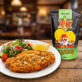 Atomic Chicken Schnitzel Herb & Garlic Coating — golden crumbed chicken schnitzel with a herby crust, lemon and side salad