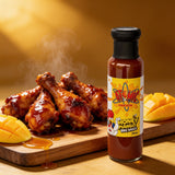 Atomic Chicken Honey Mango BBQ Sauce 250ml — glazed BBQ drumsticks with fresh mango and honey drizzle beside the bottle