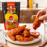 Atomic Chicken Hot 'N Spicy Southern Fried Chicken Coating — crunchy spicy chicken tenders being dipped in sauce