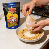 Atomic Chicken Original Southern Fried Chicken Coating 500g — hands crumbing raw chicken in the coating at the kitchen bench