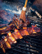 BBQ Companion by Ben O'Donoghue hardback cookbook — smoked beef short ribs with nam prik pla being basted