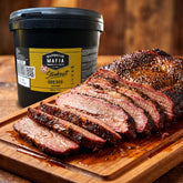 Barbecue Mafia OG Steakout BBQ Rub 2kg — a whole sliced smoked brisket platter beside the catering tub