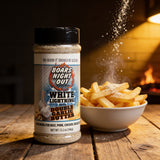 Boars Night Out Double Garlic Butter seasoning falling onto a bowl of hot chips