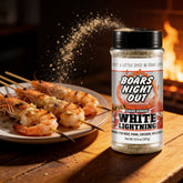 Boars Night Out Spicy White Lightning seasoning falling onto skewered prawns over a grill