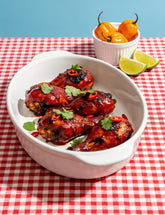 Chicken drumsticks glazed with Booma's BBQ Boomenero spicy BBQ sauce, with fresh habaneros