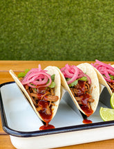 Pulled pork tacos with Booma's BBQ Boomenero spicy habanero BBQ sauce and pickled onion