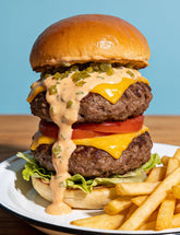 Double beef cheeseburger with Booma's BBQ Burger Sauce, creamy pickle-flecked special sauce, with fries