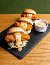 Crumbed fried chicken sliders topped with Booma's BBQ Burger Sauce