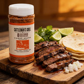 Cattleman's Grill 8 Second Ride Carne Asada Seasoning 283g — beauty shot, glistening grilled carne asada strips fresh off the cast iron, plated with lime and coriander