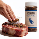 Cattleman's Grill Original Cowboy Coffee Steak Rub 283g — action shot rubbing a raw ribeye