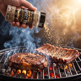 Big GCs Godfather Magic rub shaken onto steak and ribs on the grill