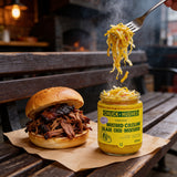 Chuck Hughes Mild Mustard Coleslaw 375ml mustard slaw relish — forkful of mustard coleslaw lifted from an open jar beside a smoked pulled pork roll