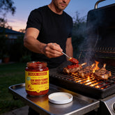 Chuck Hughes Mild Sun-Dried Tomato Spread 375ml tomato spread — spooning sun-dried tomato spread over lamb cutlets on the grill