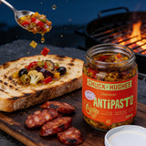 Chuck Hughes Spicy Antipasto 375ml antipasto condiment — spicy antipasto tipped onto charred sourdough beside grilled chorizo