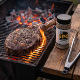 Chuds BBQ SPG 235g salt, pepper and garlic seasoning — thick-cut ribeye searing over glowing charcoal