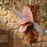 Coast n Smoke The 13th Apostle rub — carving juicy herb-crusted gyros lamb from a vertical spit