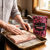 Coast n Smoke Bacon Cure — home cook rubbing the cure over a raw pork belly to make homemade bacon