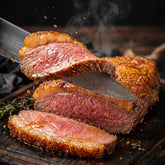 Coast n Smoke Bahia Barrels rub — slicing grilled picanha to reveal a juicy rosy-pink medium interior