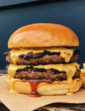The Stowaway lifestyle — double smash cheeseburger with melted cheese and chips