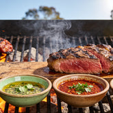 El Chori Chimichurri Four Pack — coriander, smoky paprika and jalapeño chimichurri bowls beside a carved rump steak