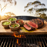 El Chori Chimichurri Four Pack — all four chimichurris served with sliced medium-rare steak on a timber board