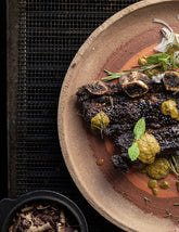 Fire Kitchen by Adam Roberts hardback cookbook — sliced steak with green sauce on a plate over the grill