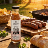 Flavour & Spice Aztec Tomato Relish spooned over grilled sausages on the barbecue
