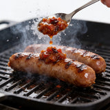 Flavour & Spice Aztec Tomato Relish being spread onto a burger patty in action