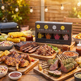 Four Saucemen The Barbecue Gift Box - the gift box beside a backyard BBQ spread
