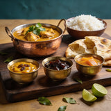 Goan Cuisine Chutney Trio bundle — three chutneys on a curry night table with chicken curry, rice and naan
