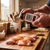 Hardcore Carnivore Cajun Rub — home cook seasoning raw chicken from the shaker
