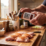 Hardcore Carnivore Cajun Rub — home cook seasoning raw chicken from the shaker